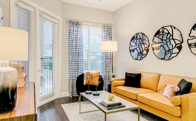 Oak Lawn Apartments near Turtle Creek living room with yellow couch and assorted decorations
